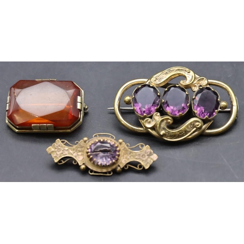 429 - 2 Victorian pinchbeck brooches set with purple stones and another silver gilt amber coloured brooch ... 