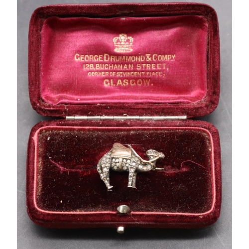 433 - A 19th Century silver and gold small brooch in the form of a camel, inset with rough cut diamonds an... 