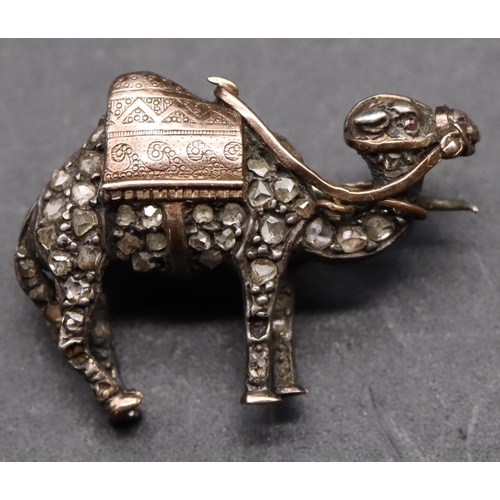 433 - A 19th Century silver and gold small brooch in the form of a camel, inset with rough cut diamonds an... 