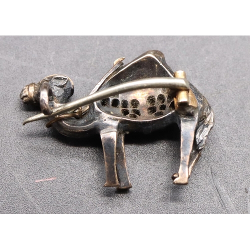 433 - A 19th Century silver and gold small brooch in the form of a camel, inset with rough cut diamonds an... 