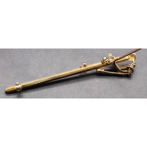 434 - A 9ct gold bar brooch in the form of a sword with white and black enamelled decoration, 6.3cm long, ... 