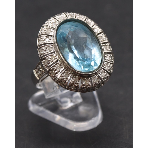 439 - A white gold large oval ladies' cluster ring set with aquamarine surrounded by small diamonds, size ... 