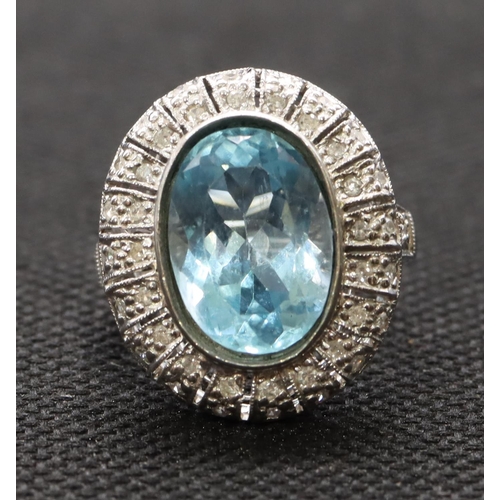 439 - A white gold large oval ladies' cluster ring set with aquamarine surrounded by small diamonds, size ... 