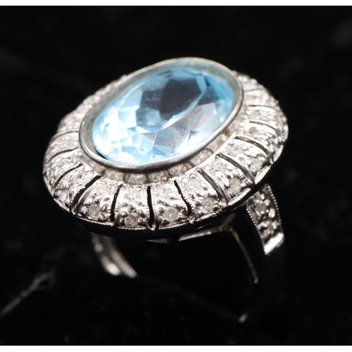 439 - A white gold large oval ladies' cluster ring set with aquamarine surrounded by small diamonds, size ... 