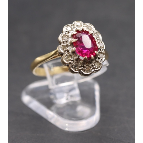 441 - An 18ct gold ladies' oval cluster ring set with centre ruby surrounded by diamonds, size K, 3.3 gram... 