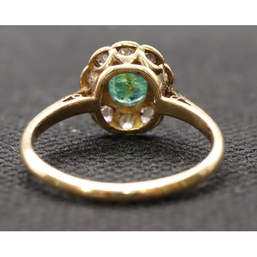 442 - A ladies' gold  oval cluster ring set with centre emerald surrounded by small diamonds, size P, 2.8 ... 