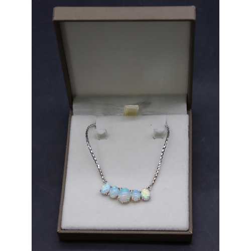 445 - A 9ct white gold drop necklace mounted with 5 opals, 53cm long, 8.6 grams gross