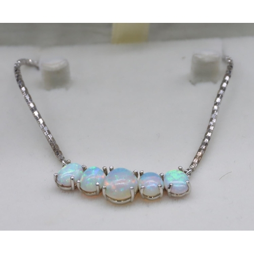 445 - A 9ct white gold drop necklace mounted with 5 opals, 53cm long, 8.6 grams gross