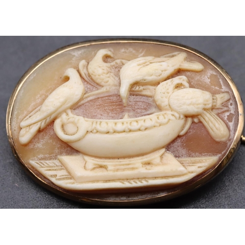 447 - A 9ct gold oval cameo brooch with raised urn and bird motifs, 3cm wide, 3.8 grams gross