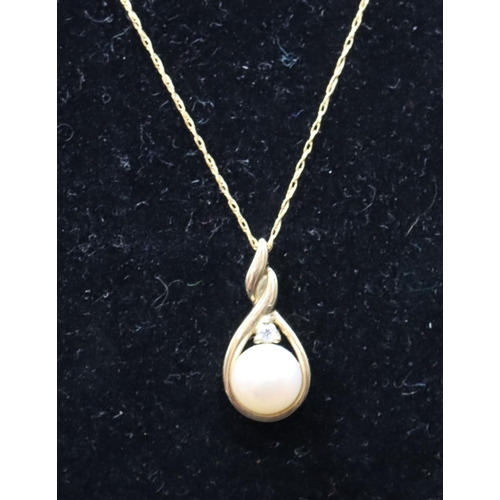 448 - A 9ct gold pendant set with pearl and single diamond, with chain, 2.2 grams gross