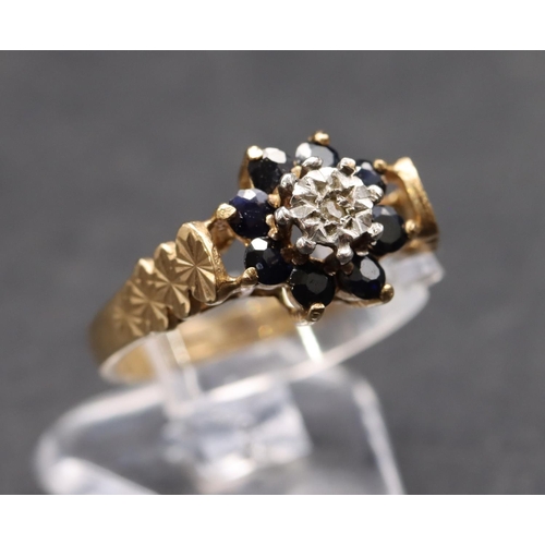 449 - A 9ct gold ladies' cluster ring set with small centre diamond surrounded by sapphires, size L, 2.5 g... 