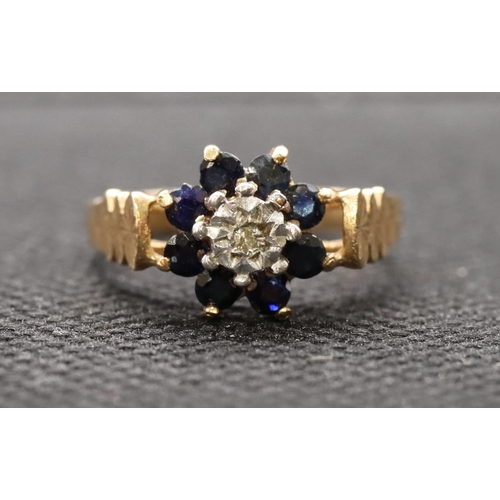 449 - A 9ct gold ladies' cluster ring set with small centre diamond surrounded by sapphires, size L, 2.5 g... 