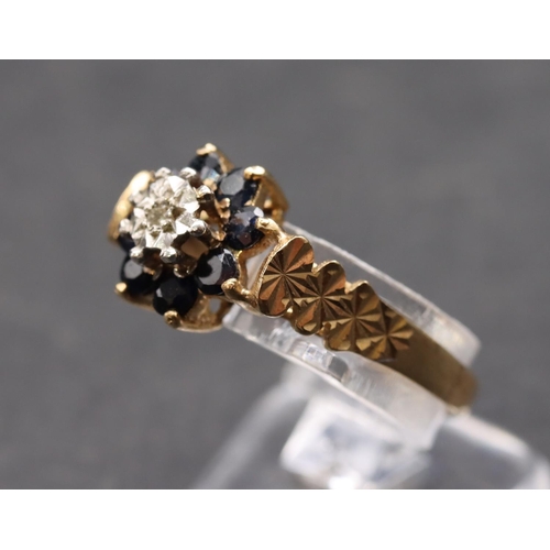 449 - A 9ct gold ladies' cluster ring set with small centre diamond surrounded by sapphires, size L, 2.5 g... 