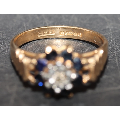 449 - A 9ct gold ladies' cluster ring set with small centre diamond surrounded by sapphires, size L, 2.5 g... 