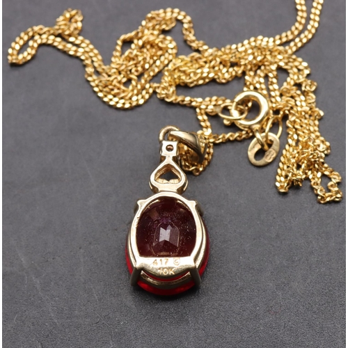 452 - A 10ct gold pendant set with ruby mounted with small diamond, with chain, overall weight 5.2 grams g... 