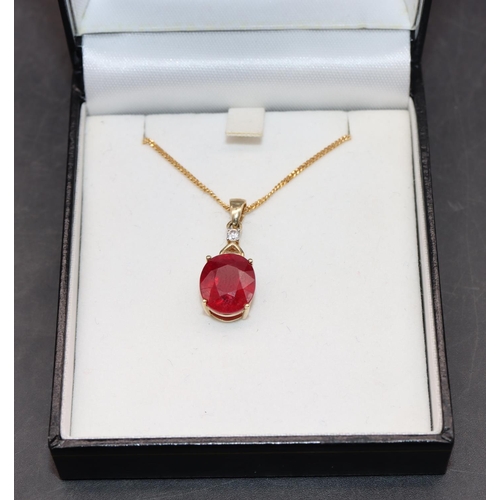 452 - A 10ct gold pendant set with ruby mounted with small diamond, with chain, overall weight 5.2 grams g... 