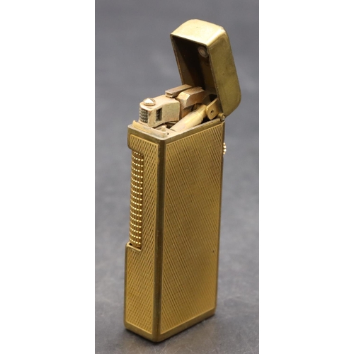 455 - A gold plated Dunhill lighter with allover engine turned decoration (Worn) (Cased)