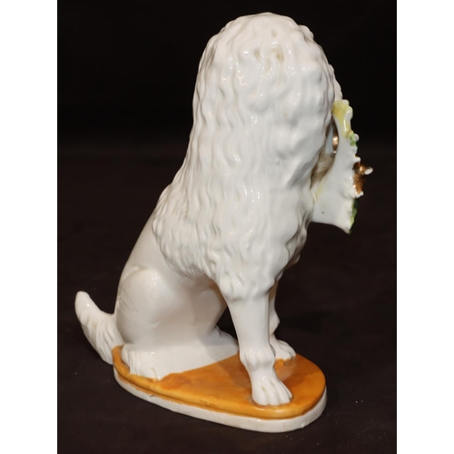 46 - A Bisque Staffordshire style figure of a seated spaniel holding basket in its mouth, 19cm high