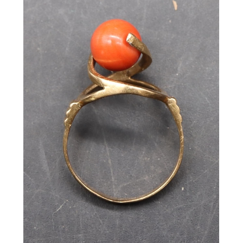 489 - A Continental gold ladies' ring set with coral, with open shoulders, size O/P, 3.5 grams gross