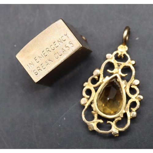 491 - A 9ct gold charm enclosing a Ten Shilling note, a 9ct gold small locket with Citrine style stone, 4.... 