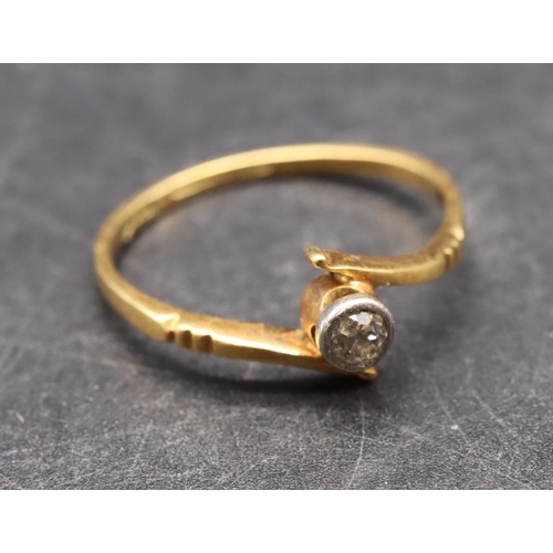 494 - An 18ct gold small solitaire diamond ring with twist shoulders, size O, 1.8 grams gross