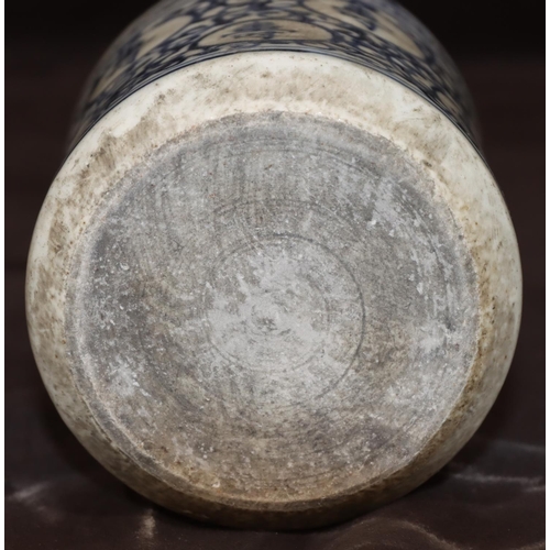 50 - An Oriental cylindrical blue and white brush pot with allover inscription and scroll decoration, 11.... 