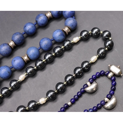 503 - A blue bead and silver necklace, a metal bead and silver necklace and a small lapis lazuli and silve... 