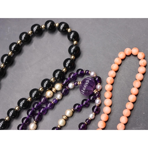 505 - An amethyst style pearl and gold bead necklace with 9ct gold clasp, a coral bead necklace with 9ct g... 