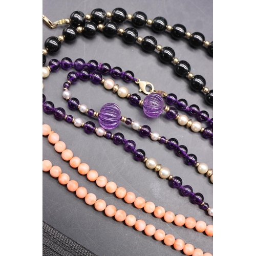 505 - An amethyst style pearl and gold bead necklace with 9ct gold clasp, a coral bead necklace with 9ct g... 