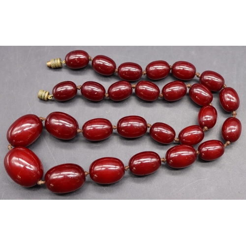 508 - A dark amber graduated bead necklace, 65 grams gross