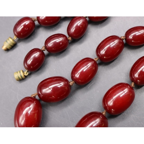 508 - A dark amber graduated bead necklace, 65 grams gross