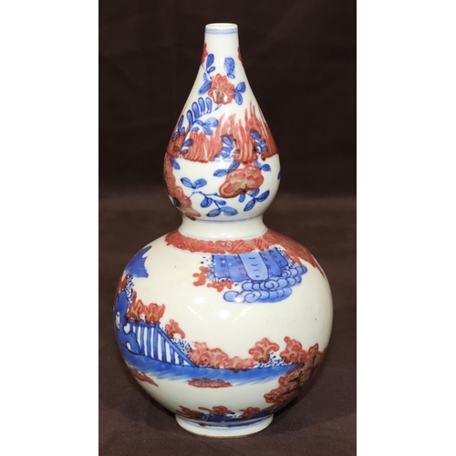 51 - An Oriental round gourd shaped vase on white, red and blue ground with figure decoration, 22.5cm hig... 