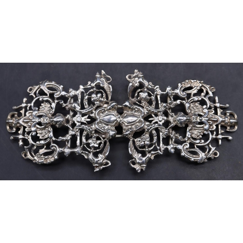 516 - A Victorian London silver nurses buckle with raised cupid, floral, leaf and scroll decoration, 12.5c... 