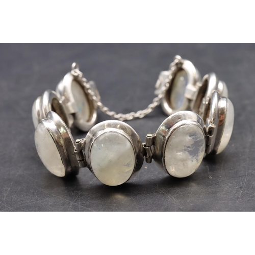 518 - A silver bracelet set with 8 milky Labradorite style stones