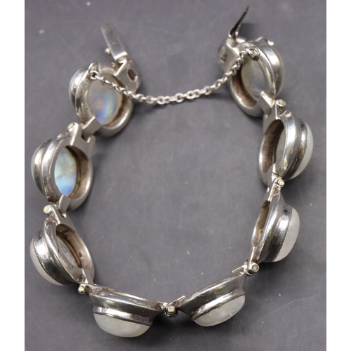 518 - A silver bracelet set with 8 milky Labradorite style stones