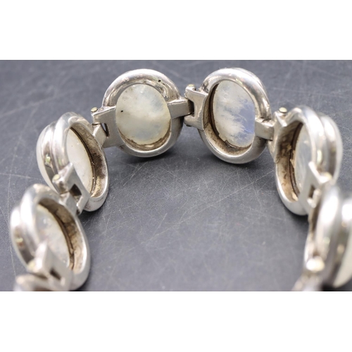 518 - A silver bracelet set with 8 milky Labradorite style stones