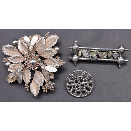 520 - A large silver brooch in the form of a flower mounted with 3 flies, 6cm wide, a Scottish Iona silver... 