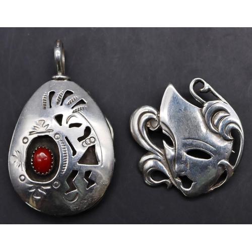 522 - A Birmingham silver mask shaped brooch, maker's mark SWJ and a sterling silver pendant set with turq... 