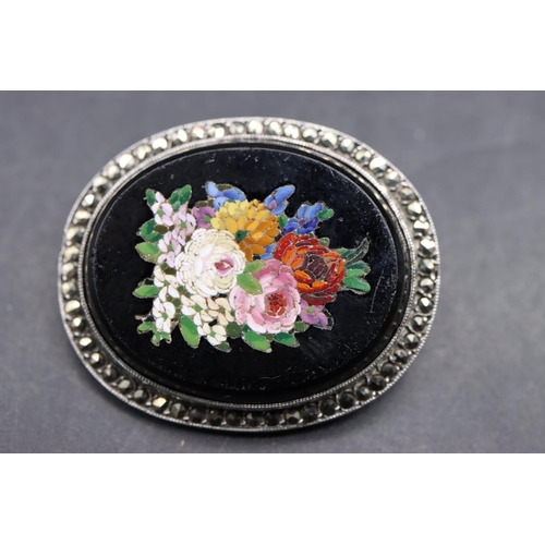 523 - A silver oval micro mosaic brooch with multi-coloured floral centre and cut steel rim, 3.2cm wide