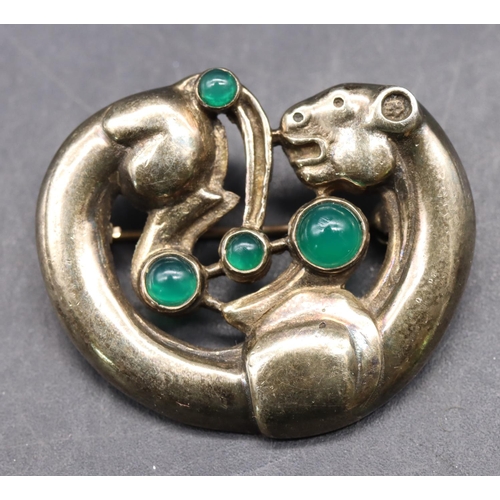 525 - An Arts & Crafts style silver gilt brooch in the form of an animal mounted with 4 green carbuncles, ... 