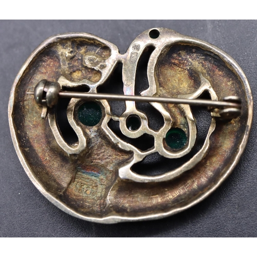 525 - An Arts & Crafts style silver gilt brooch in the form of an animal mounted with 4 green carbuncles, ... 