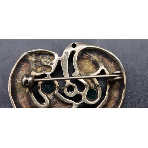 525 - An Arts & Crafts style silver gilt brooch in the form of an animal mounted with 4 green carbuncles, ... 