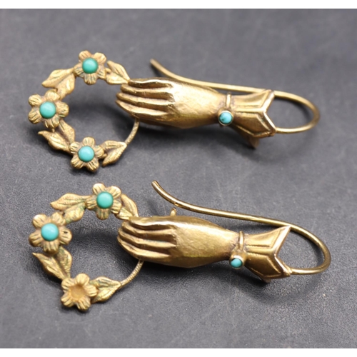 533 - A pair of 9ct gold novelty drop earrings in the form of hands holding garland mounted with turquoise... 