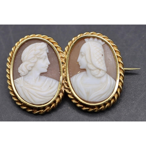 536 - A gold double oval cameo brooch with 2 raised figureheads and twist rim, 3.2cm wide, 6.3 grams gross