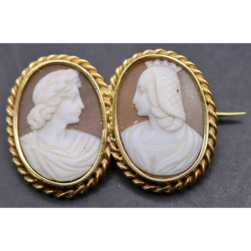 536 - A gold double oval cameo brooch with 2 raised figureheads and twist rim, 3.2cm wide, 6.3 grams gross