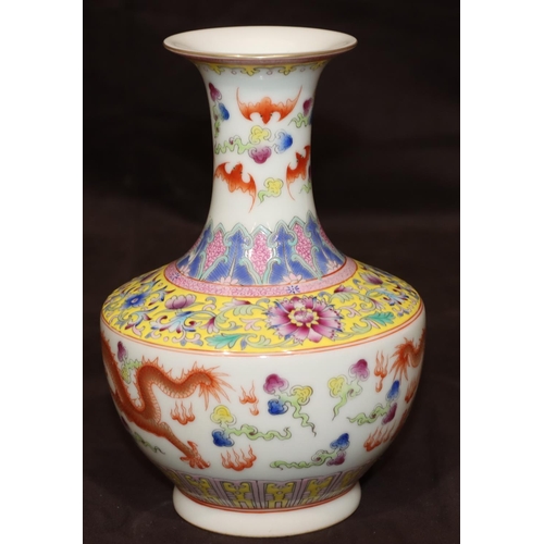 54 - An Oriental round bulbous thin necked trumpet shaped vase on white ground with multi-coloured dragon... 