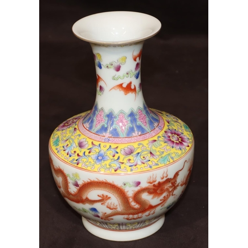 54 - An Oriental round bulbous thin necked trumpet shaped vase on white ground with multi-coloured dragon... 