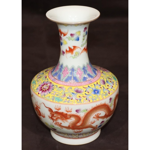 54 - An Oriental round bulbous thin necked trumpet shaped vase on white ground with multi-coloured dragon... 