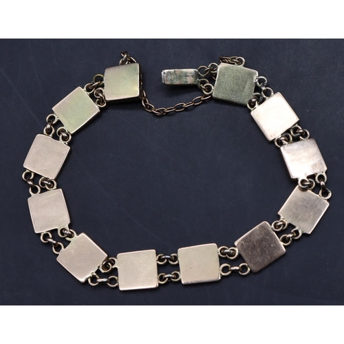 542 - A Continental gold square panel bracelet depicting various symbols, 10 grams