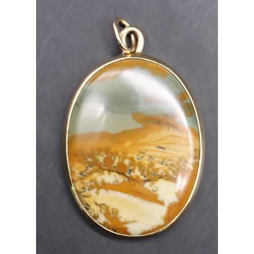 545 - A gold coloured metal oval agate coloured stone pendant, 5cm high